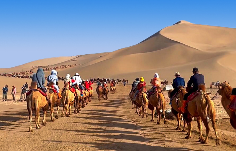 China Dunhuang Mingsha Mountain Travel Riding Camel.jpg